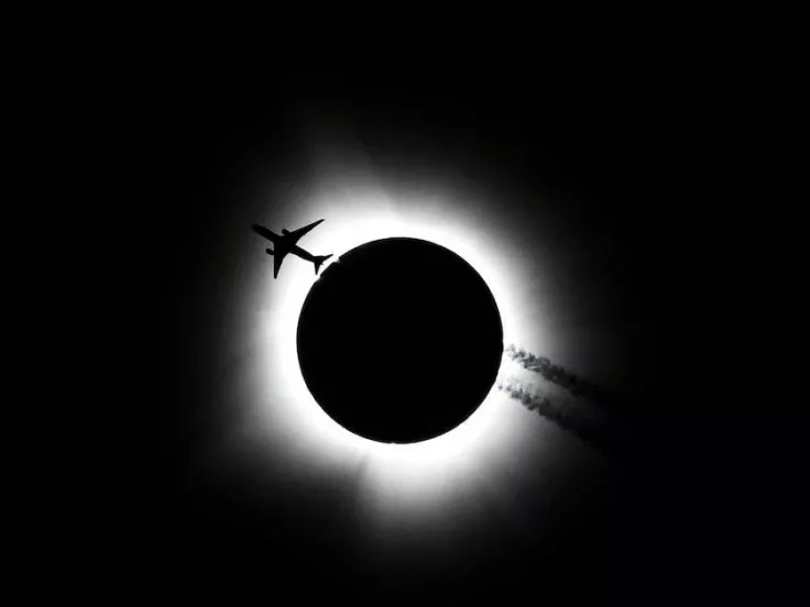An airplane passes near the total solar eclipse in Bloomington/Reuters