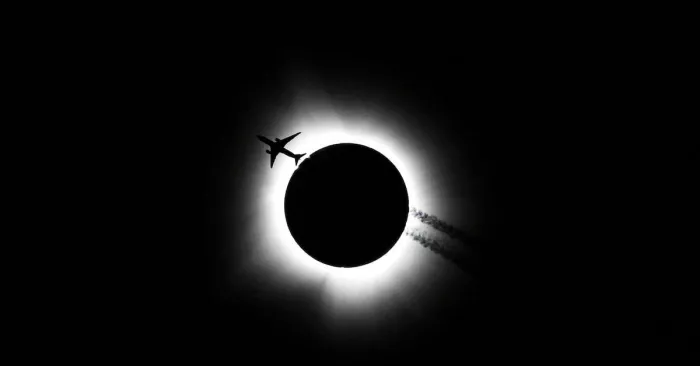 An airplane passes near the total solar eclipse in Bloomington/Reuters